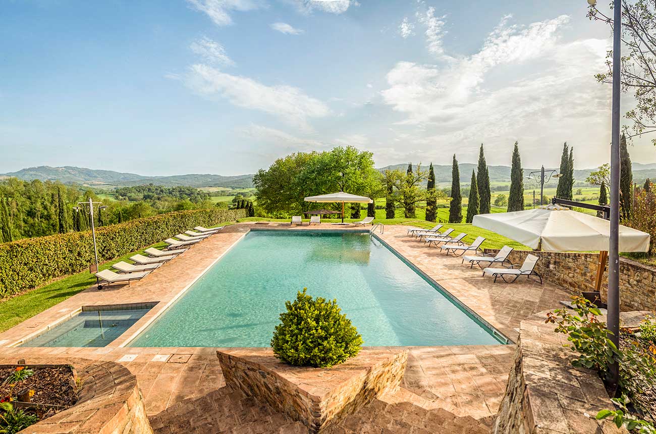 Infinity pool framed by Tuscan cypresses